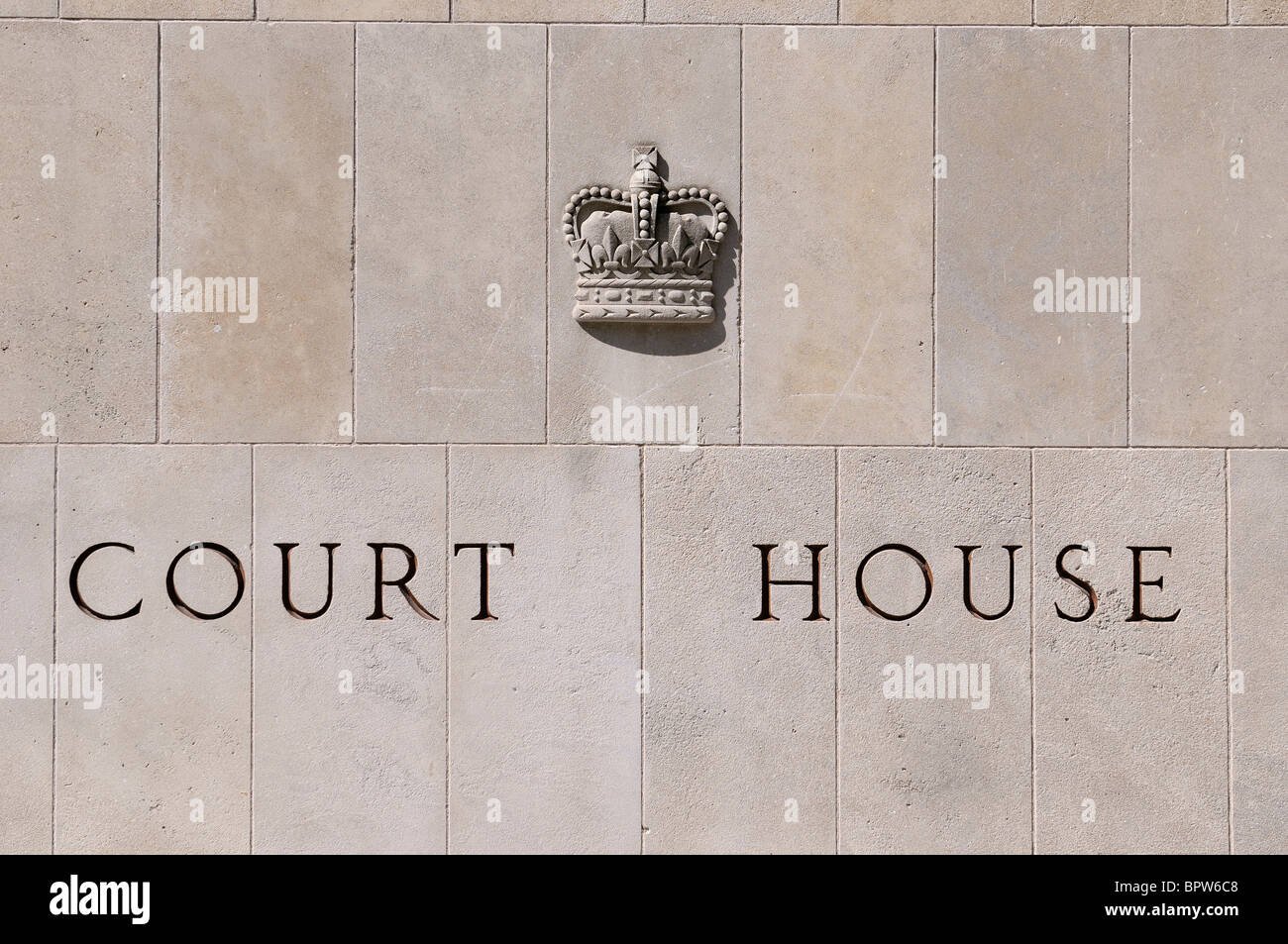 Court house carved on stone blocks with royal emblem Stock Photo