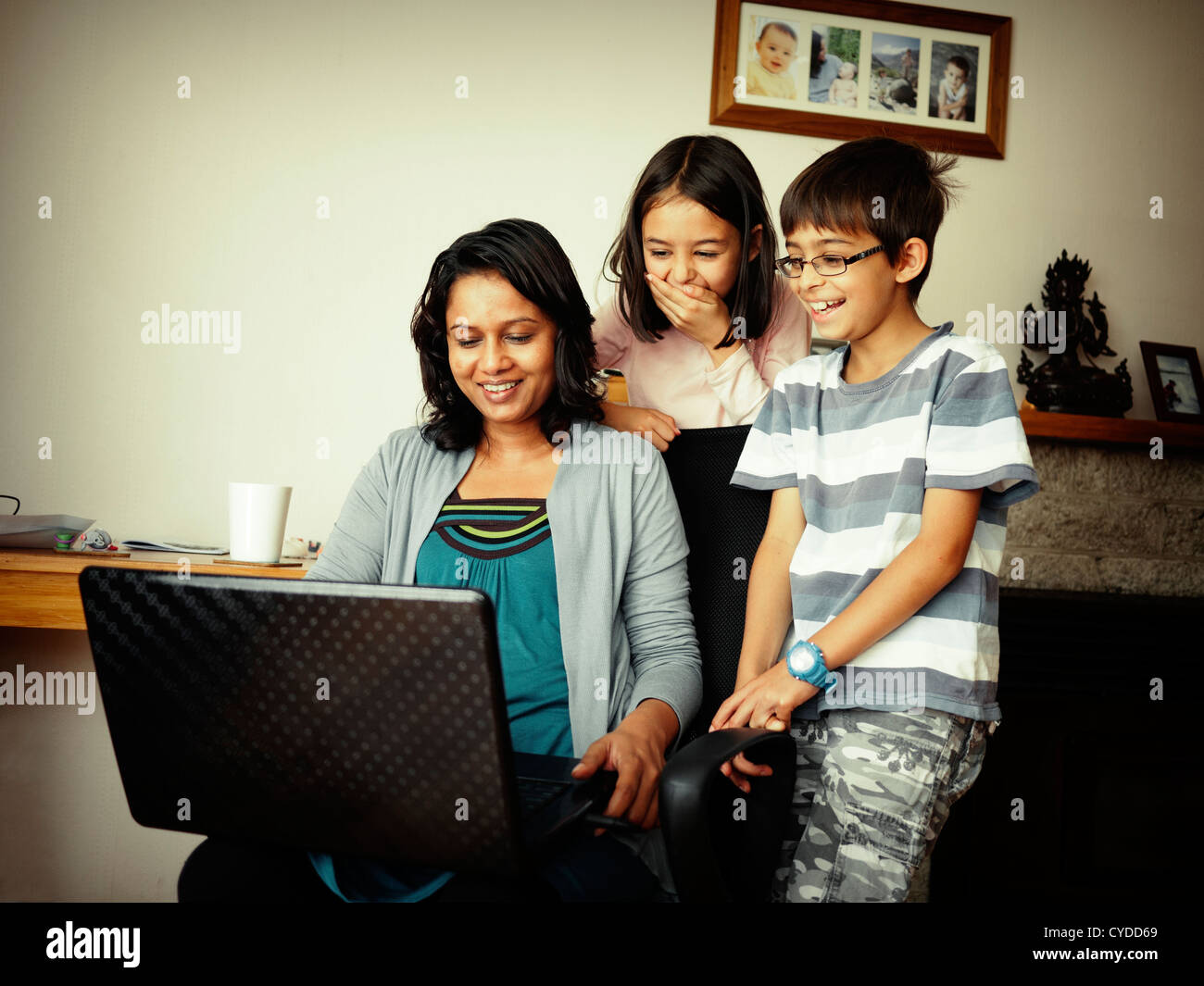 Mother, son and daughter watch videos on the web. Stock Photo