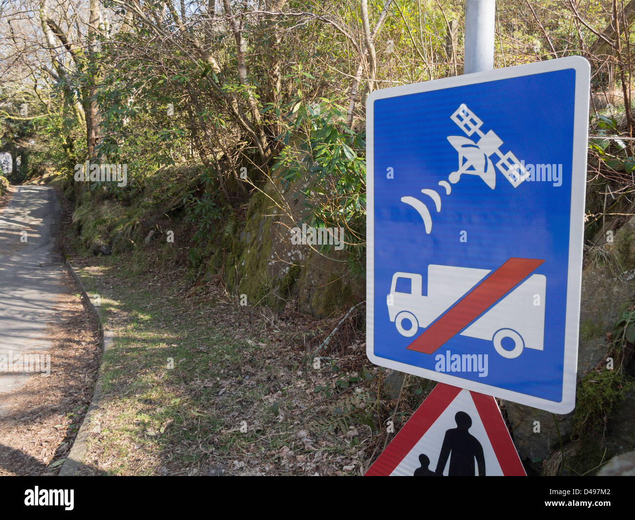 UK road sign warning lorry drivers not to use satellite navigation or sat nav on narrow country lane unsuitable for heavy goods vehicles access. Wales Stock Photo