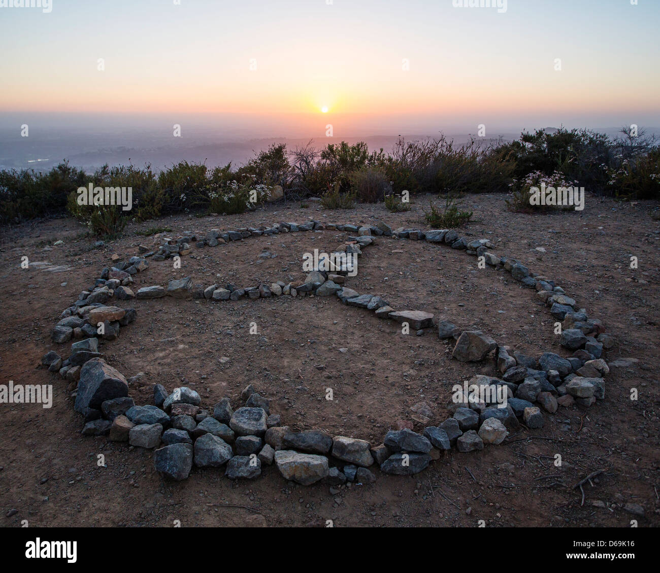 Rocks in peace symbol on cliff Stock Photo