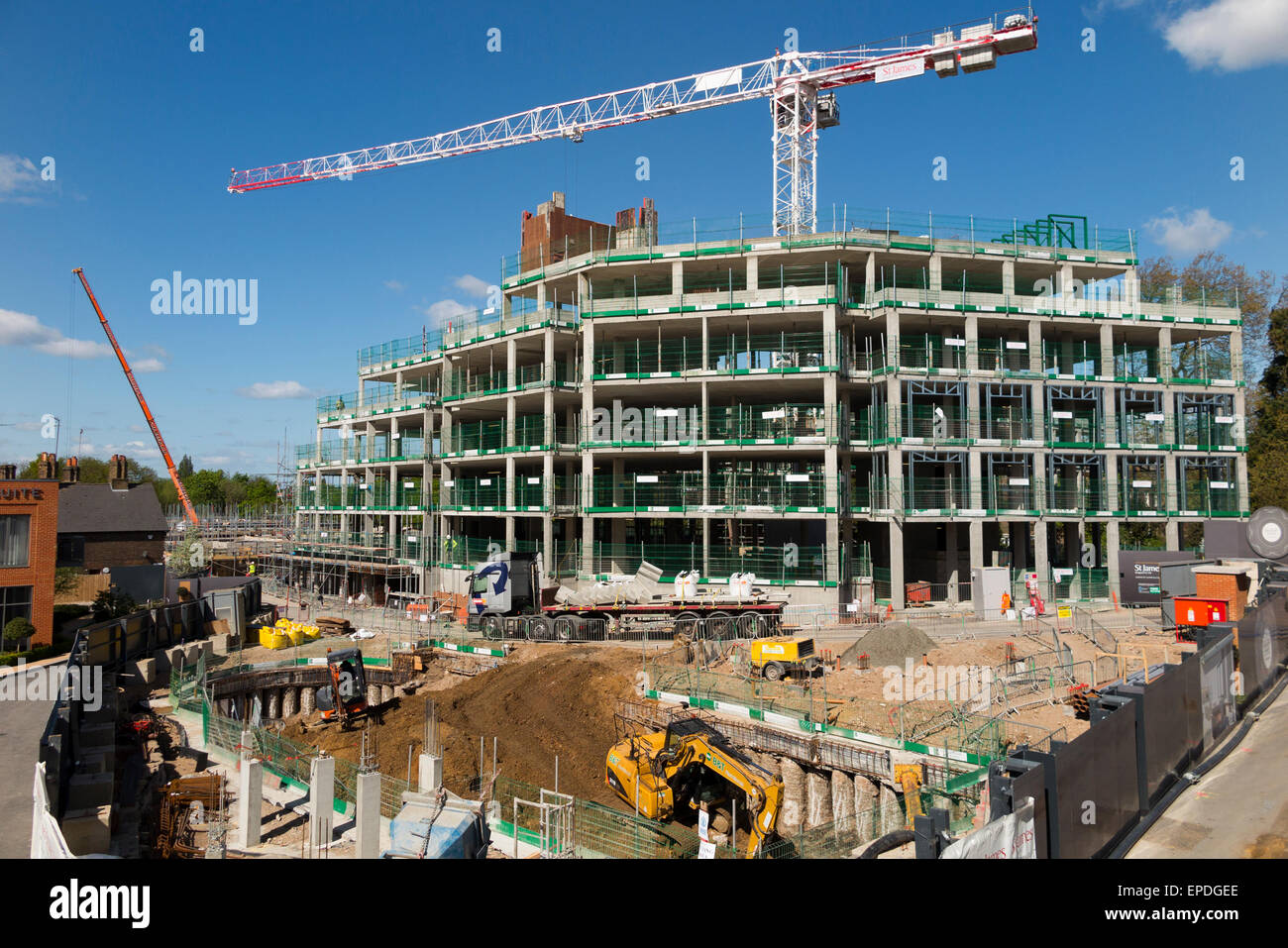 Construction site & exterior partly built housing block / new build / building apartment block / apartments / flat / flats. UK. Brownfield / brown field sites being redeveloped. Stock Photo