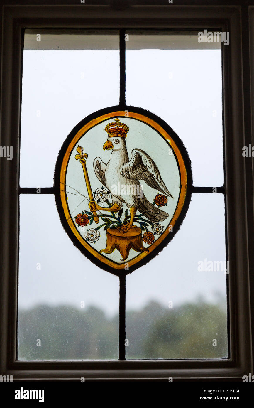 UK, England, Yorkshire.  Stained Glass Herald of Anne Boleyn, a Crowned Falcon Holding a Sceptre. Stock Photo