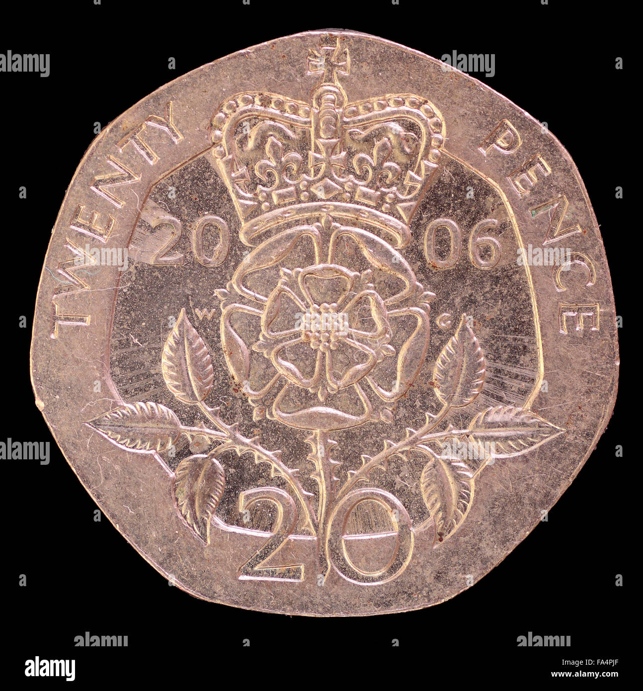 The tail face of twenty pence coin, issued by United Kingdom in 2006, depicting the royal emblem. Image isolated on black backgr Stock Photo