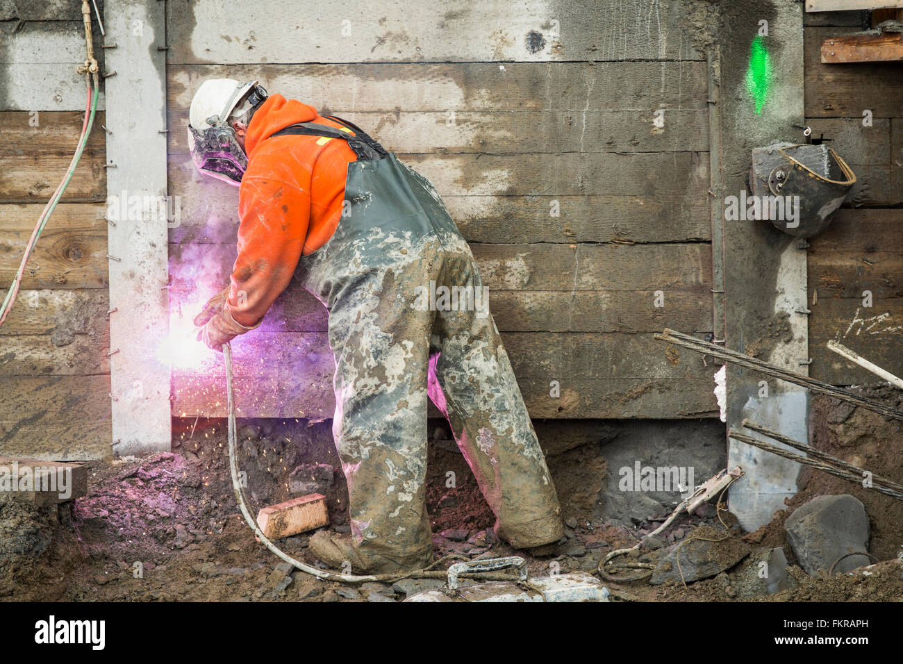 Caucasian worker welding at construction site Stock Photo