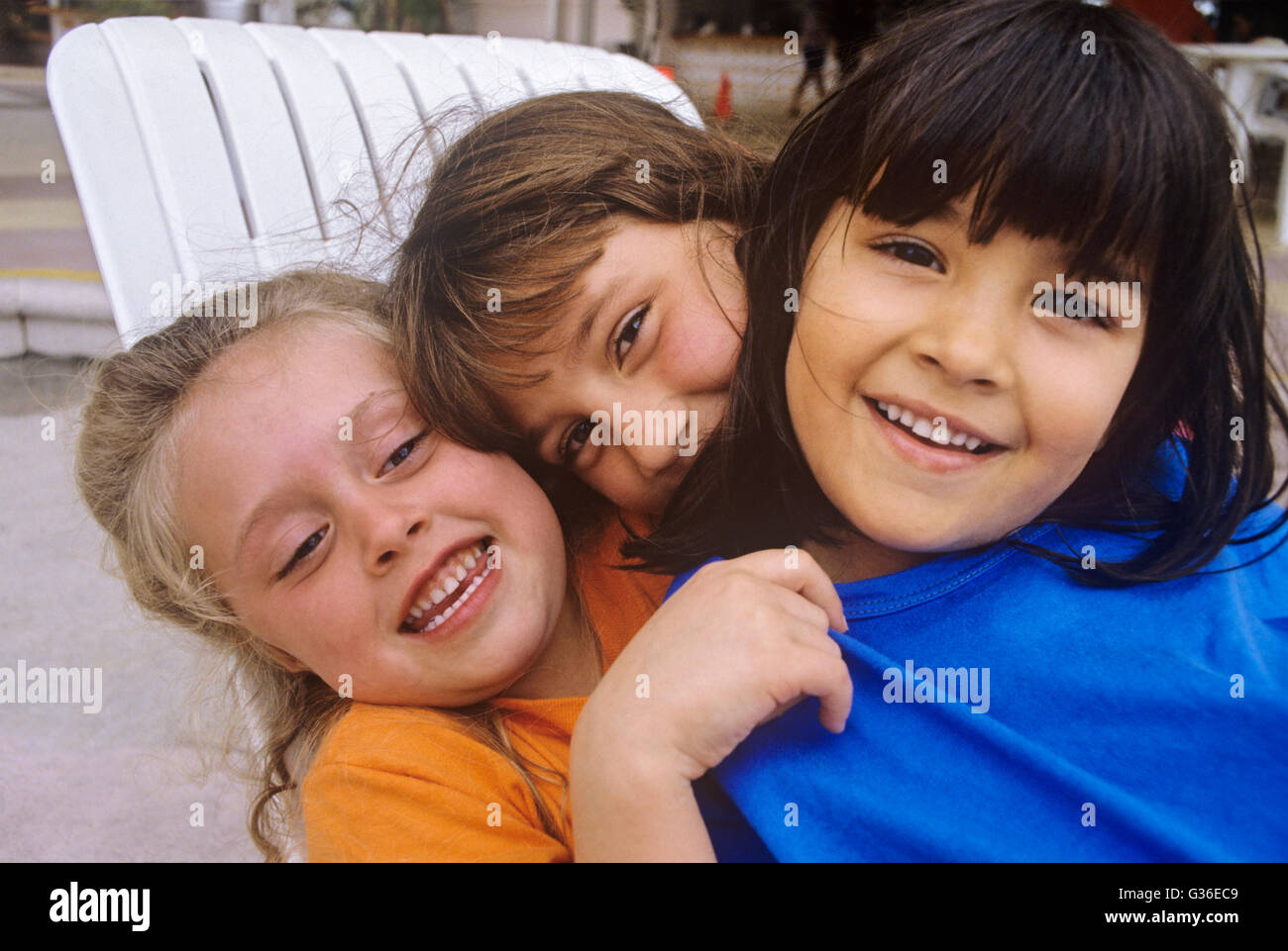 3 children hugging multi-racial group Stock Photo