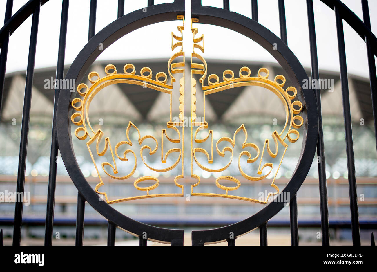 A Royal Ascot emblem is seen on the gates in front of the main grandstand during day one of the 2015 Royal Ascot Meeting at Ascot Racecourse, Berkshire. Stock Photo