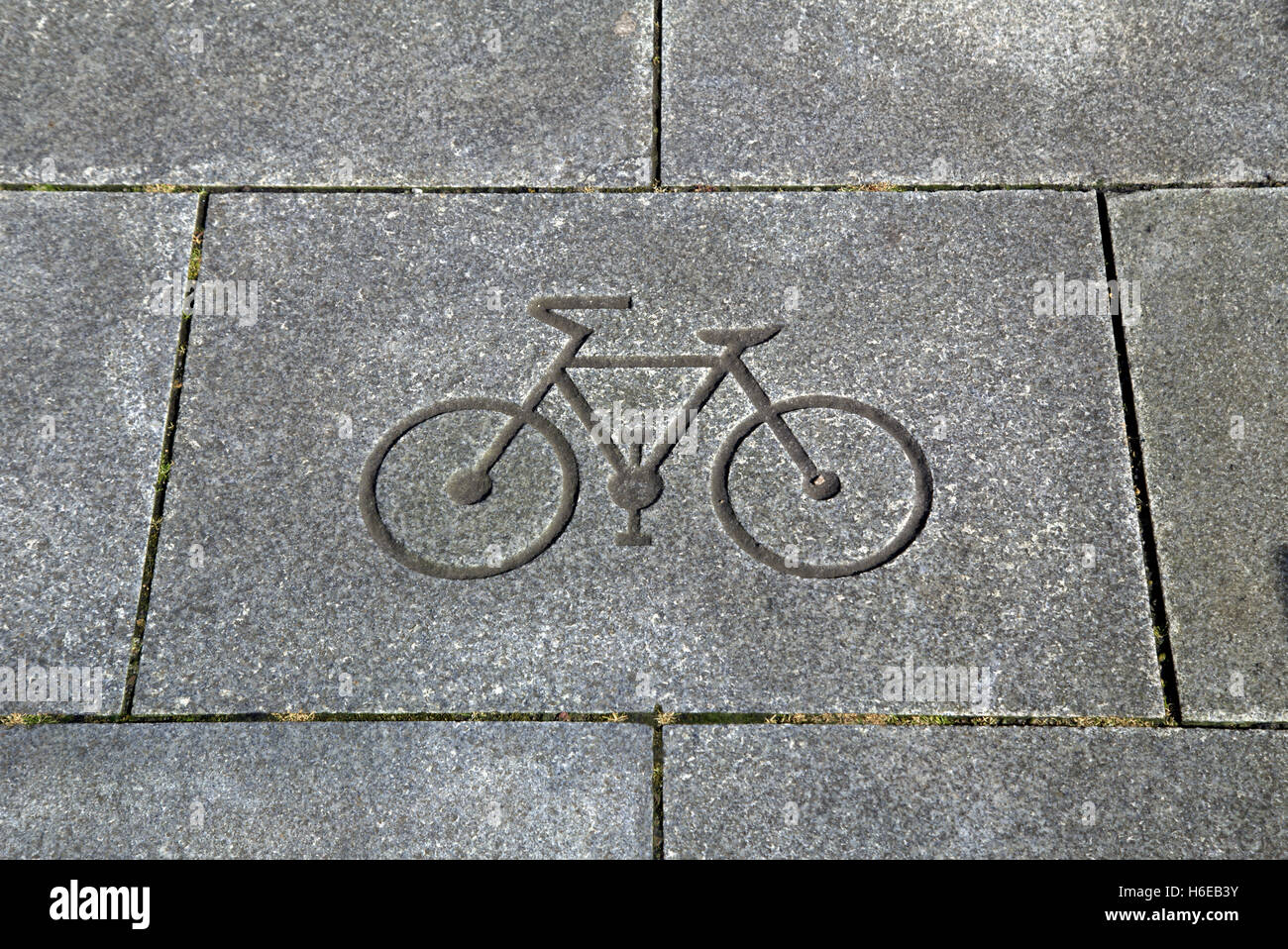 bicycle or bike symbol cut into a paving stone Stock Photo