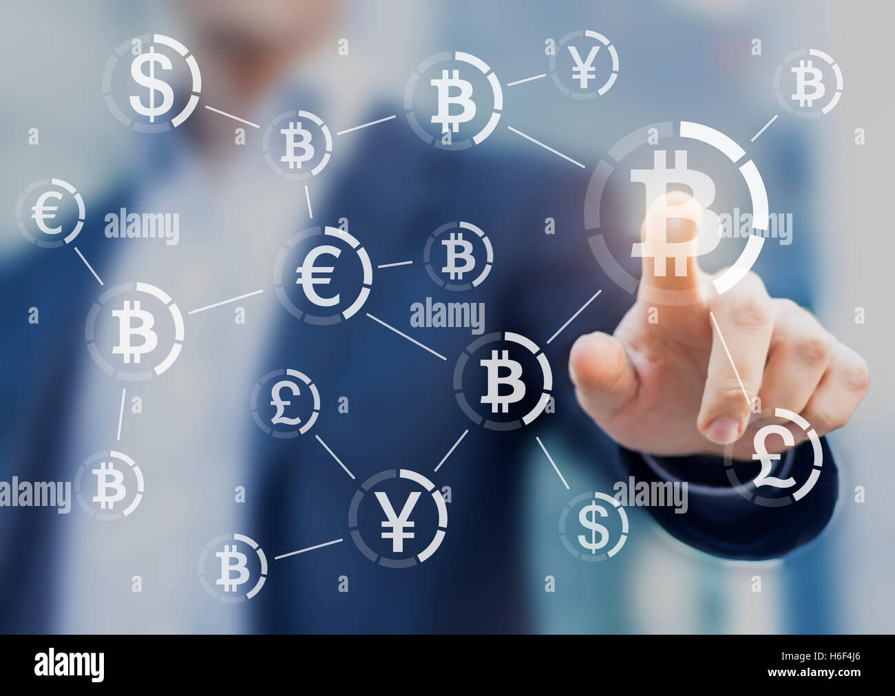 Bitcoin button on virtual interface displaying the payment system, businessman touching the currency symbol Stock Photo