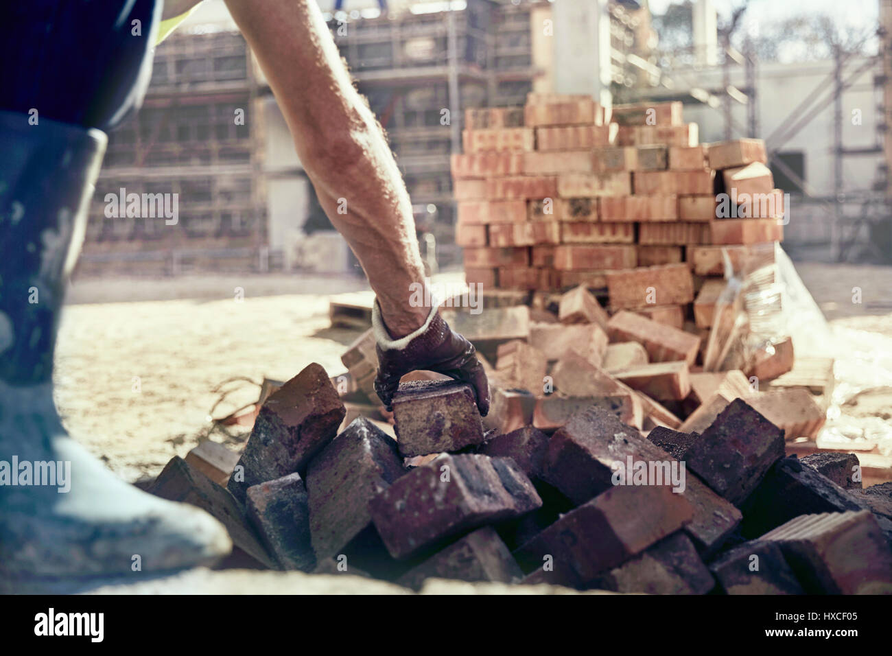 Construction worker bricklaying at construction site Stock Photo