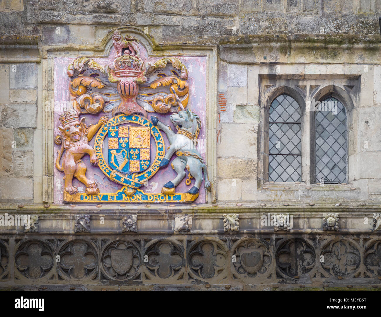 Painted royal emblem on the wall above the high street gateway to the precinct of the medieval cathedral at Salisbury, England. Stock Photo