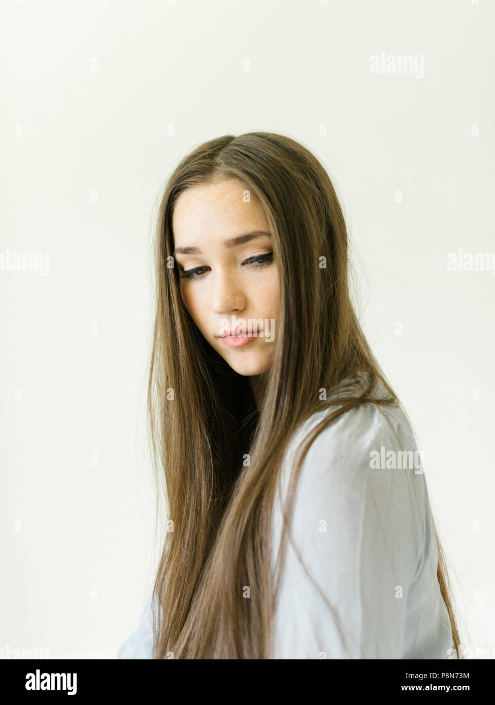 Portrait of young woman with long brown hair Stock Photo