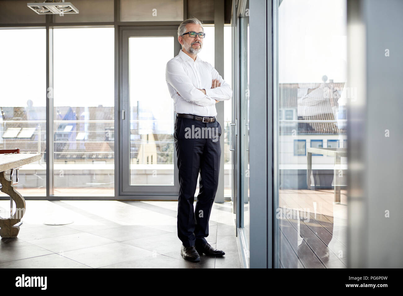 Businessman looking out of window Stock Photo