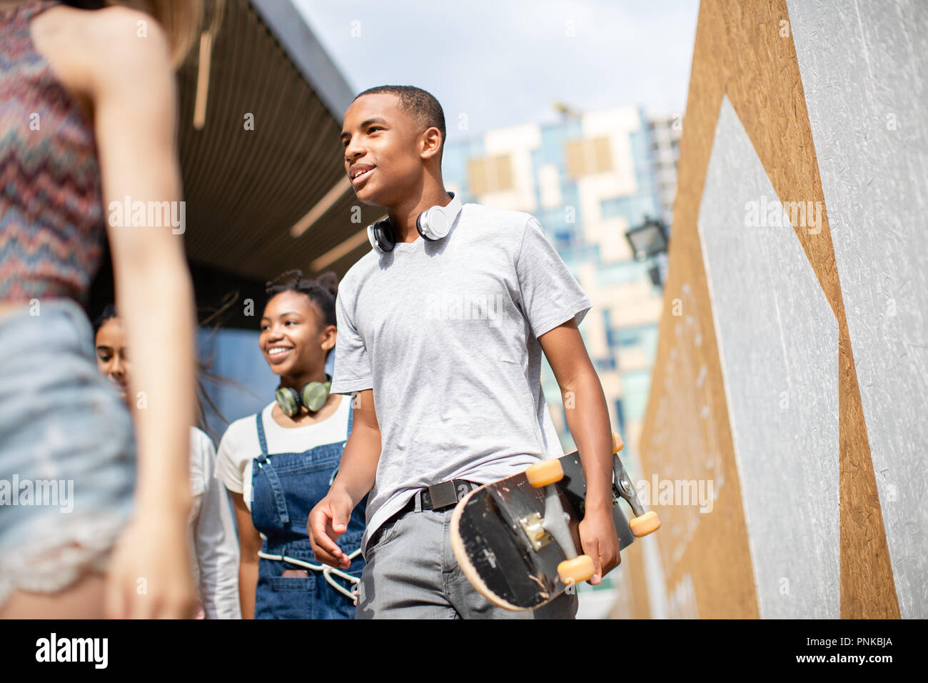 Group of teenagers walking through city Stock Photo