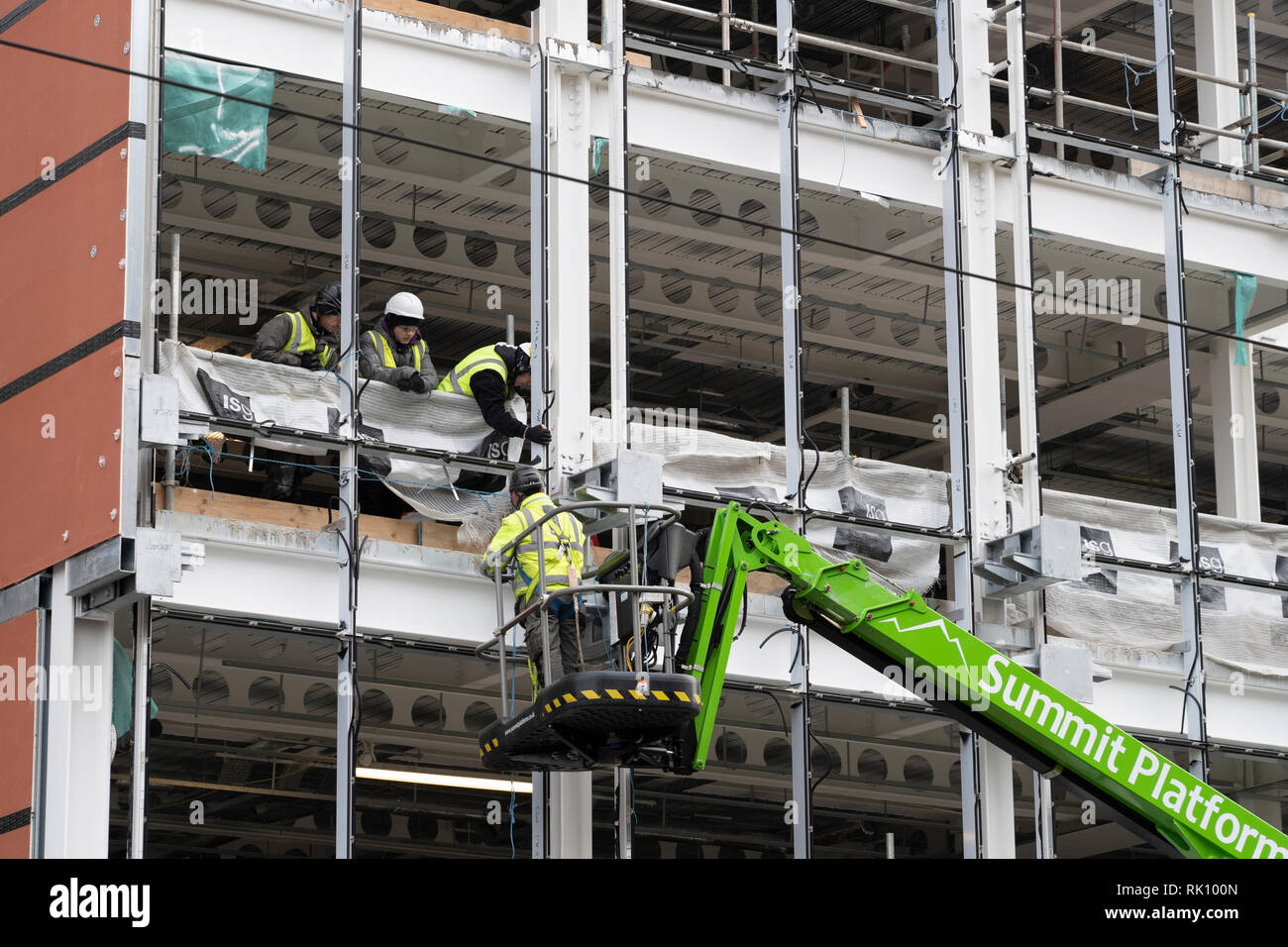 Construction workers at building site of new office building in central Edinburgh, Scotland, UK Stock Photo