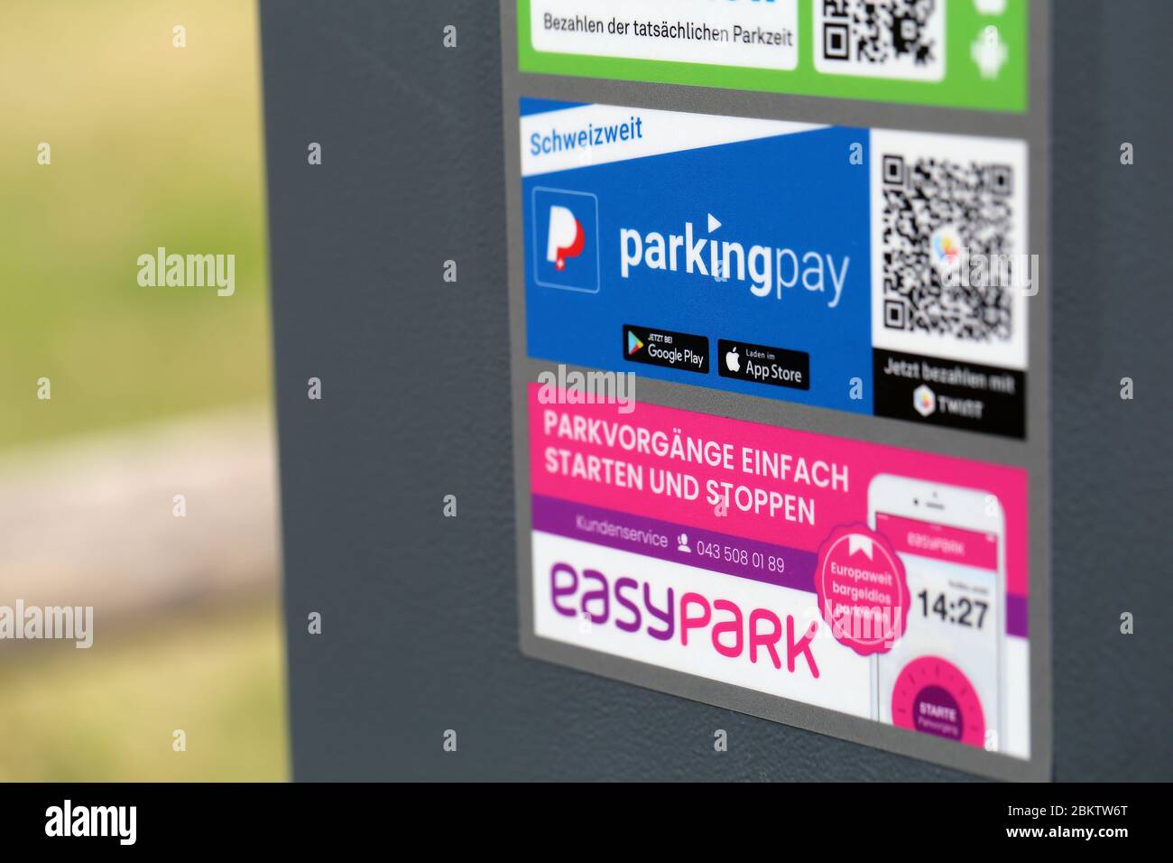 Aufkleber verschiedener Parkapps neben Parkscheinautomat in Zürich, Schweiz, März 2020. Aufkleber EasyPark, Parkingpay und ParkNow. Stockfoto