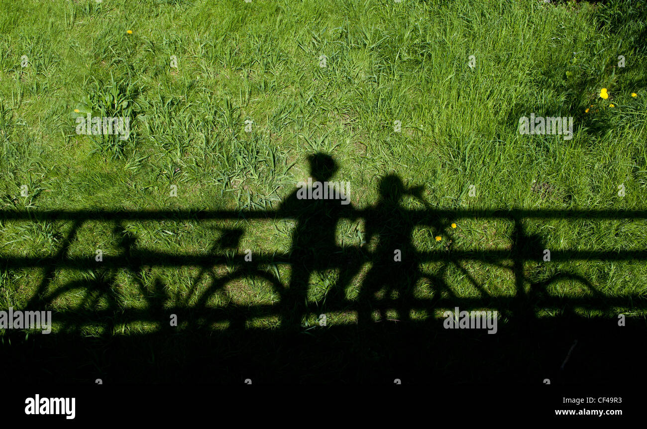 zwei Mountainbiker Silhouetten bei Stillstand auf einer Brücke Stockfoto