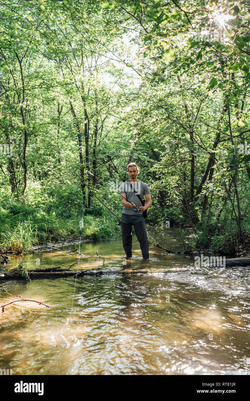 Junger Mann angeln in einem Wald Stockfoto