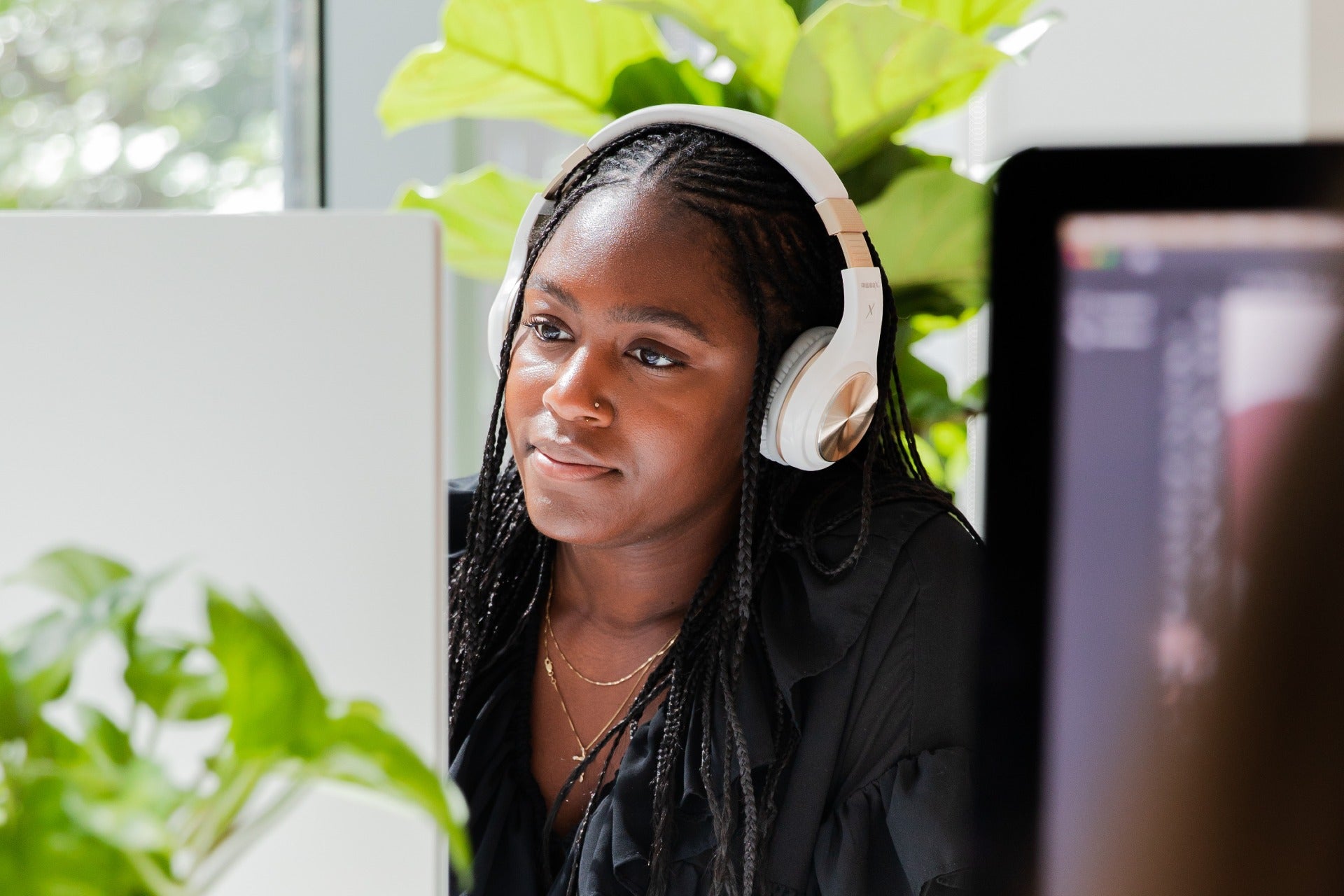 Lady with a headset looking at a screen