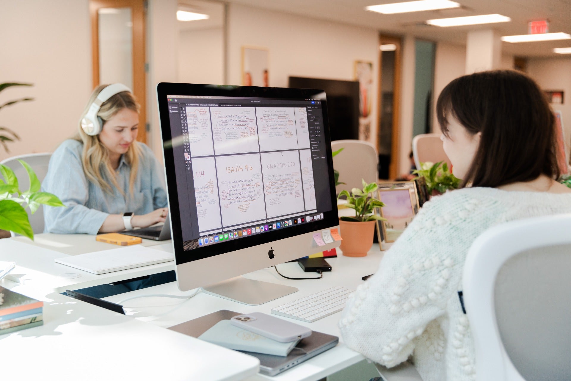 2 ladies working on desks facing each other