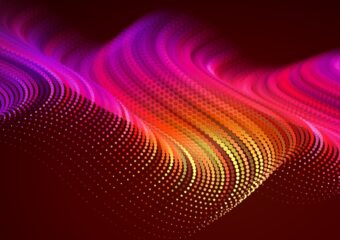 Abstract digital image of wave format in orange, red, and pink hues.