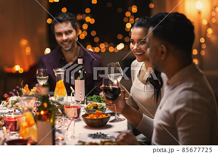 happy friends drinking wine at christmas party 85677725